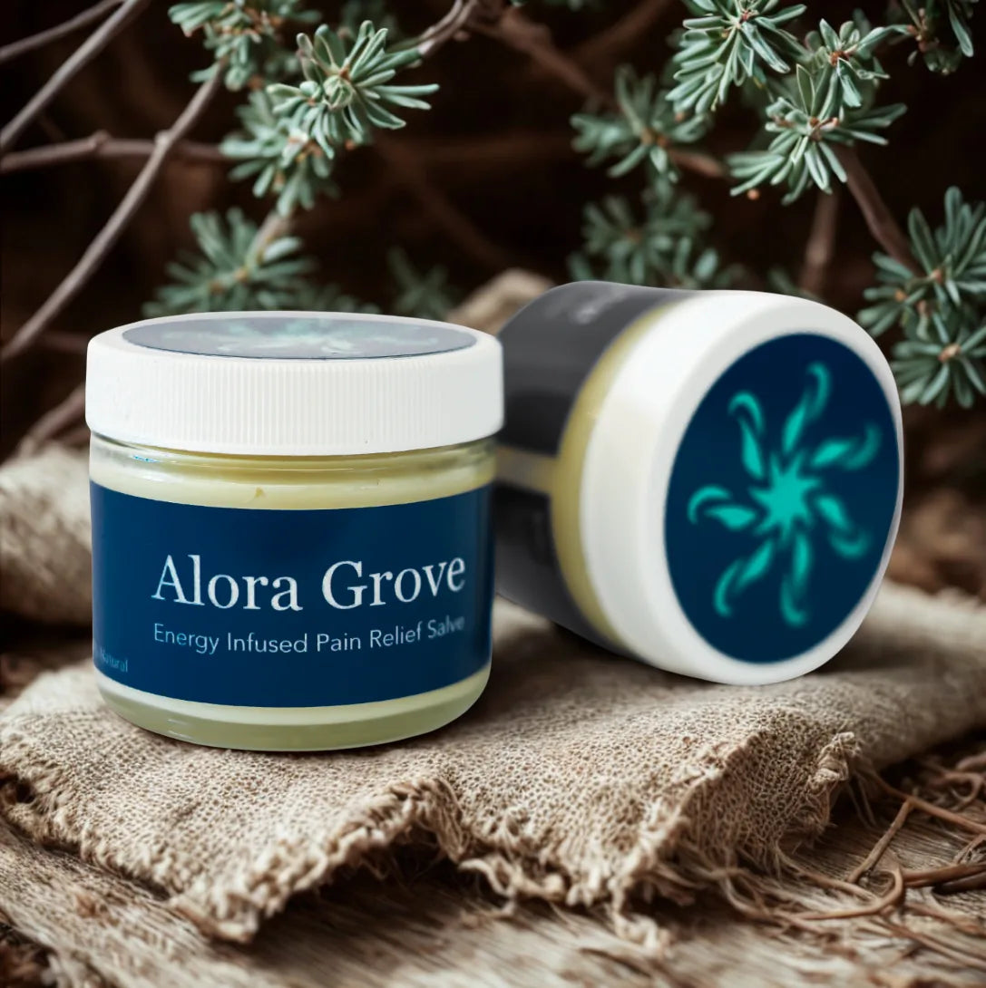 Two jars of Alora Grove pain relief salve with evergreen branches